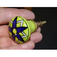 pastel green pear-shaped button and ultramarine flower