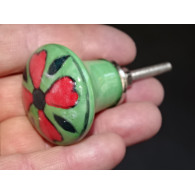 green pear shaped button and red flower