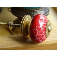 Red porcelain drawer handle and white flowers