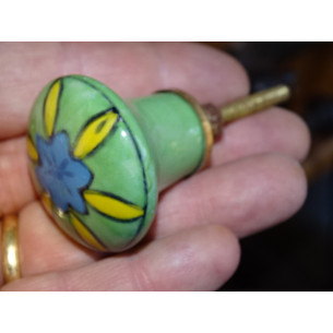 grün geformter Knopf und gelbe und türkisfarbene Blume